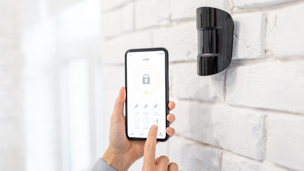 Man setting alarm on his phone